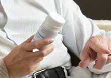Couple Holding Pill Bottle and Conducting Research