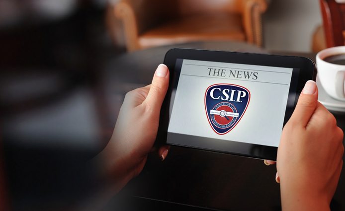 Person Reading CSIP News on Tablet