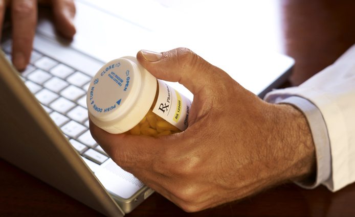 Man getting information online about prescriptions